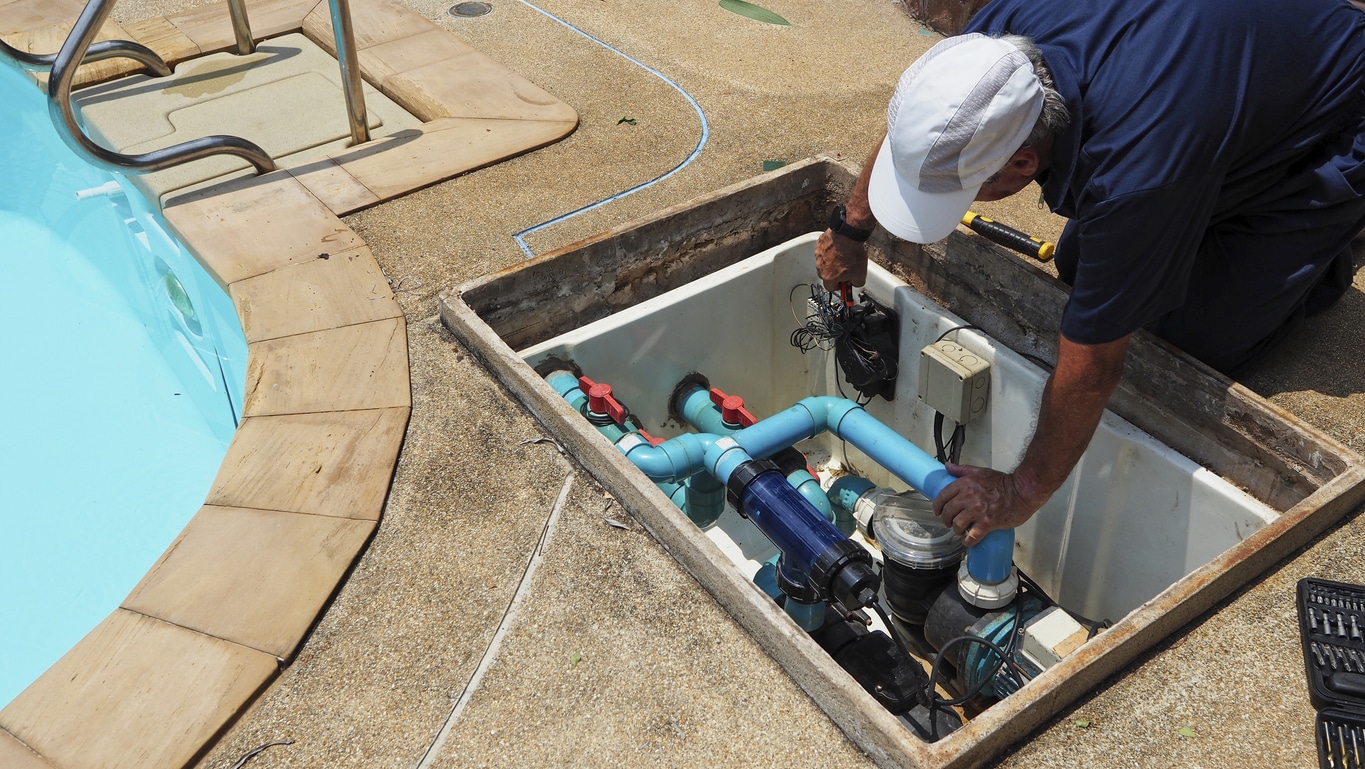 Technician repairing a residential pool pump